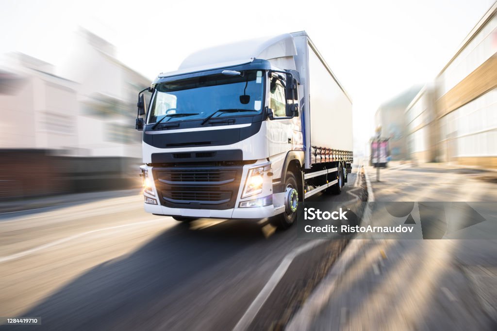 White Truck in motion isolated with clipping path JIT